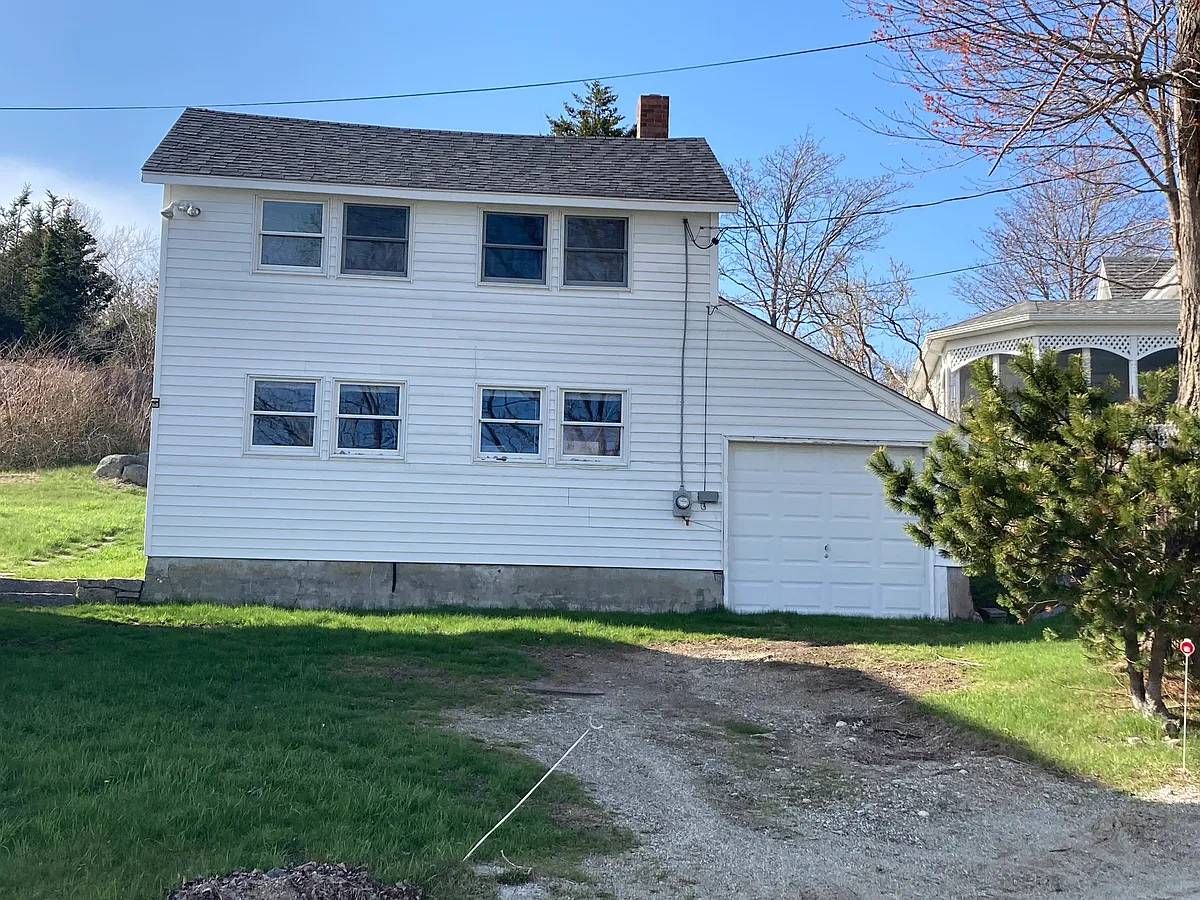 Front view of the "Loft", an upper floor studio unit above the garage/workshop at 12 Highland Ave. Top 4 windows face an extraordinary water view; there are also working windows on all other sides. Shared dooryard for parking in front of the garage door. - 12 Highland Ave