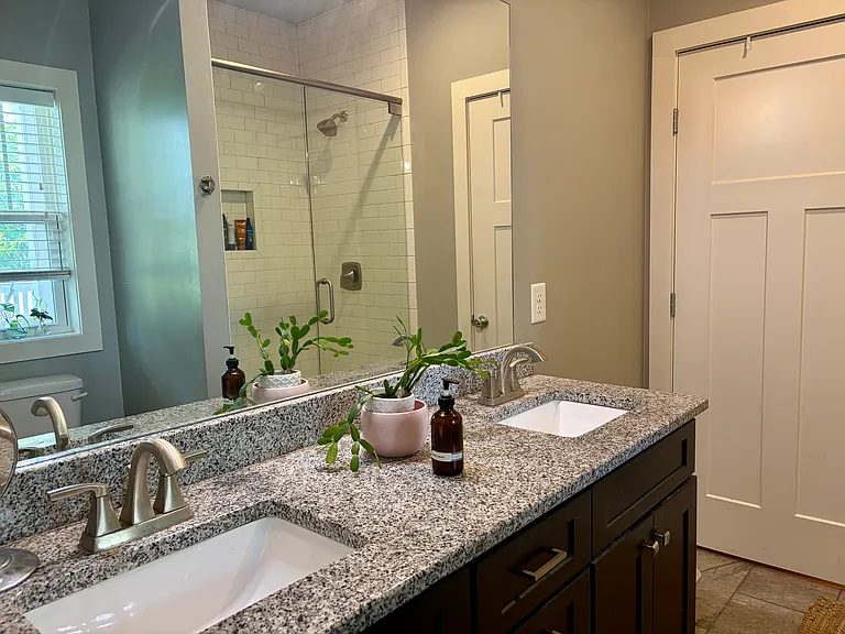 Downstairs bedroom's ensuite bathroom that is accessible from both the bedroom and the hallways - perfect for visitors. *NOTE: house comes unfurnished (pics show current owner's furnishings that will be moved).*