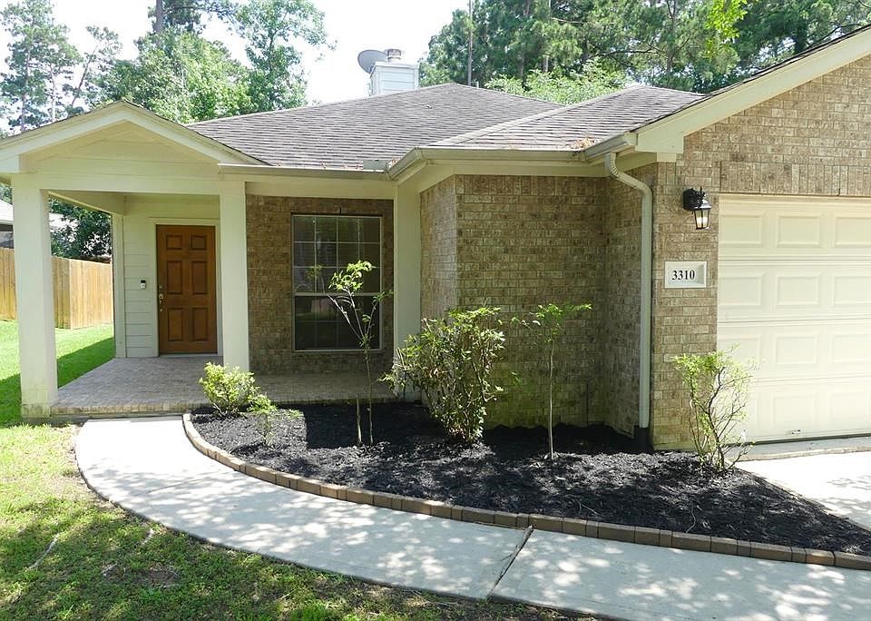 Pretty covered porch with brick patio   enough room for a sitting area or a porch swing.
