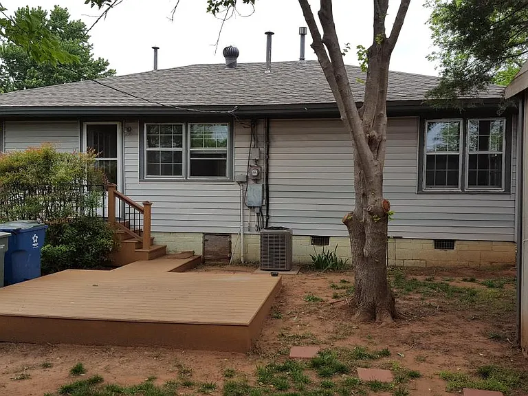 Fenced backyard with deck