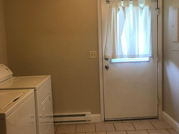 laundry room & door to back fenced in yard