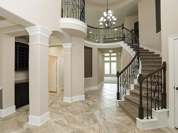 Spiral wrought iron staircase in this amazing entry!