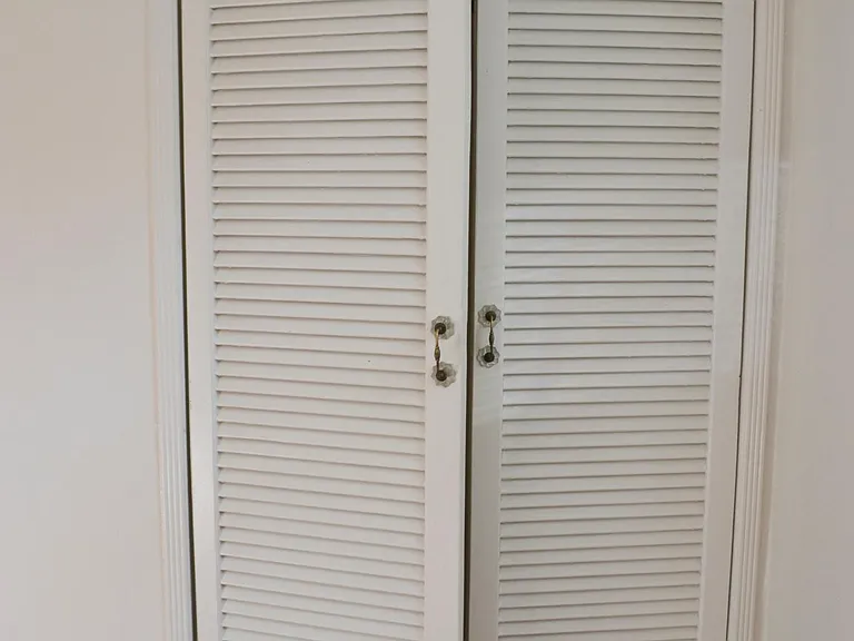 Louvered closet doors in 2nd bedroom.