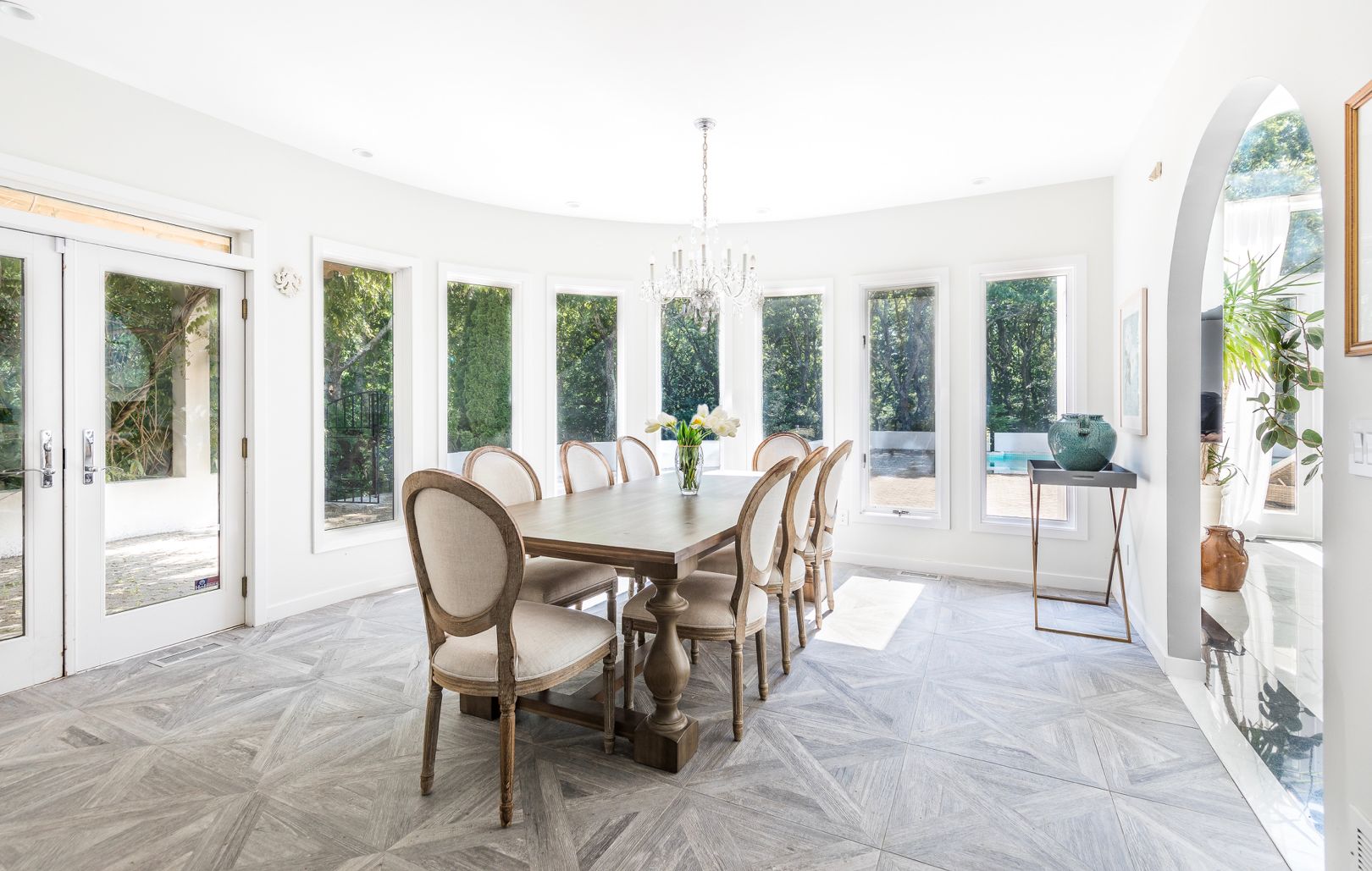  Dining room accommodates 8 seated guests. Outfitted with bay windows, Restoration Hardware furniture