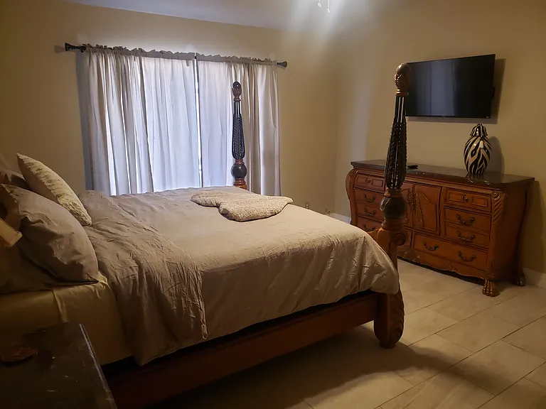 King sized bed in primary bedroom ensuite.