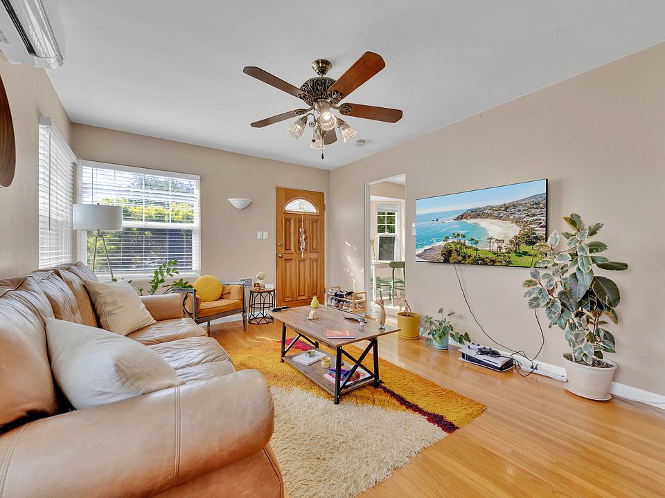 Three living room Milgard double-paned windows allow good lighting and fresh air; refinished original hardwood oak floors