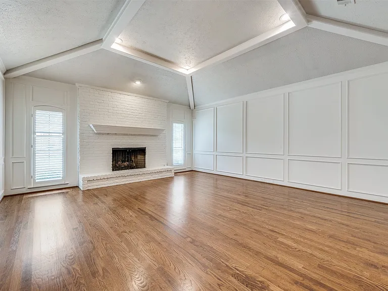 Living room with fireplace and vaulted ceiling