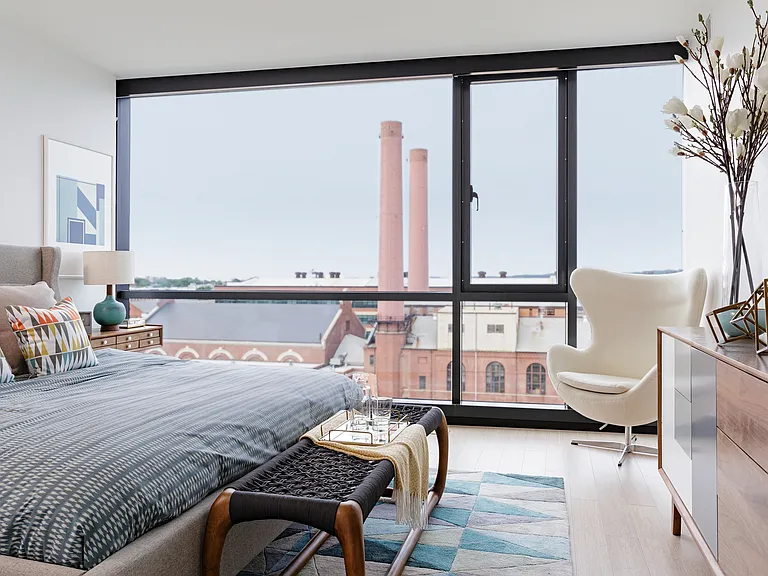 Stunning windows with roller shades offer a flood of natural light