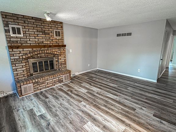 Living room with fireplace into hallway to three bedrooms