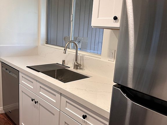 New Sink, Garbage Disposal, Dishwasher, Refrigerator and Countertop.