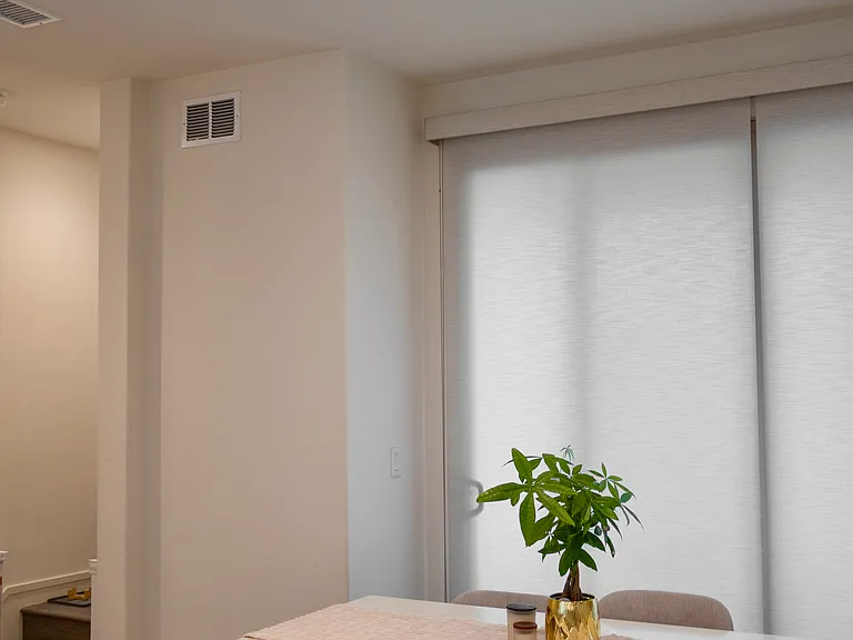 Dining Space: Features expansive sliding door windows to the patio that let in tons of sunlight, perfectly sized for a full-scale family dining table.