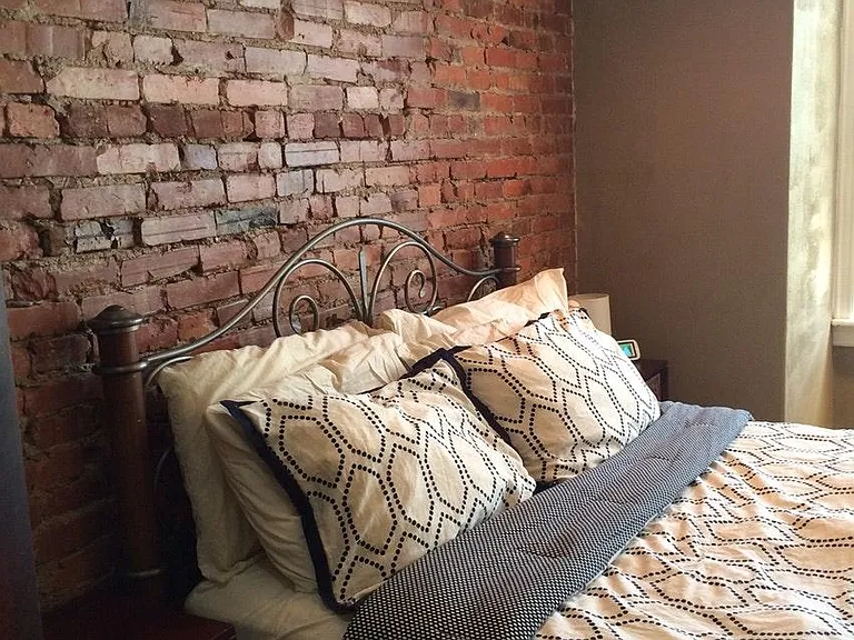 front bedroom with exposed brick wall