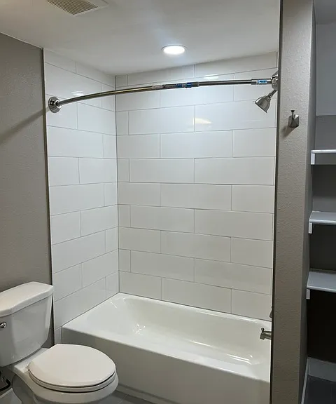 BASMENT FULL BATHROOM WITH SHELVING.