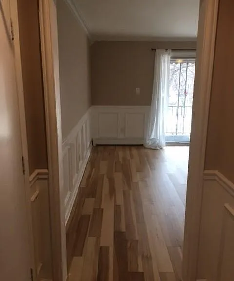 kitchen hallway facing towards the living room and balcony glass door.