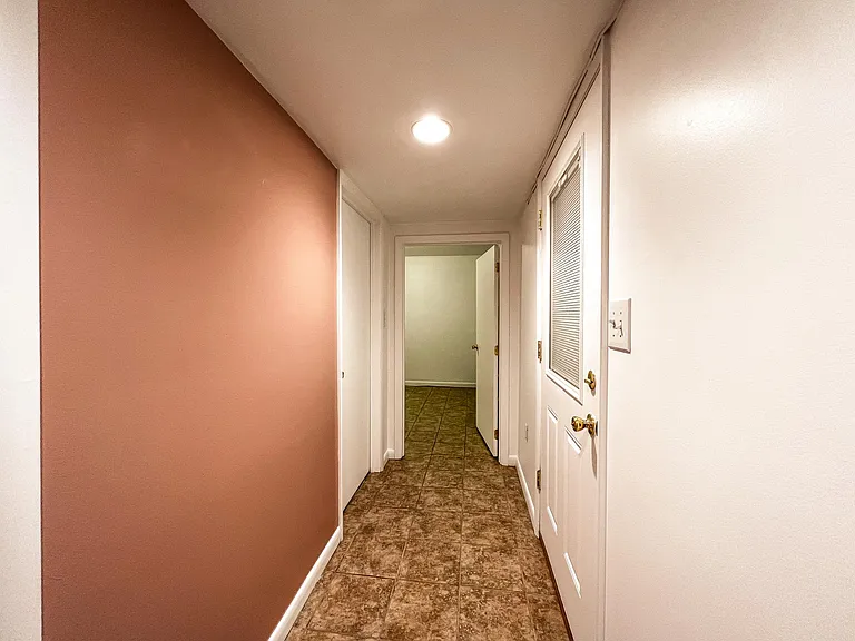 hallway...bedroom ahead, bathroom left, entrance door on right