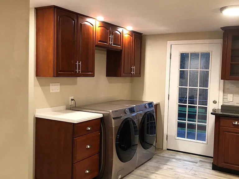 Samsung washer and dryer in kitchen, french door to deck and backyard
