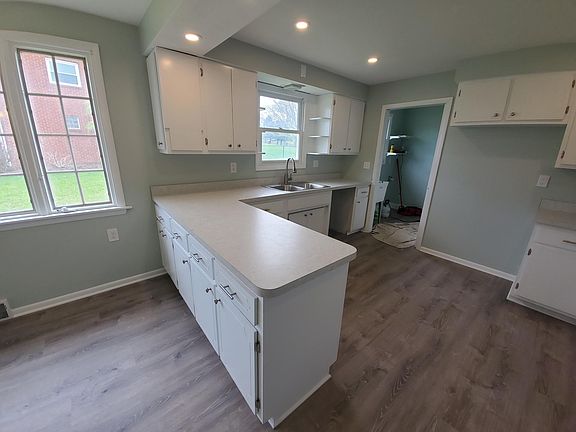 The room attached to the kitchen is the laundry room. Stainless steel appliances (not shown) have been installed