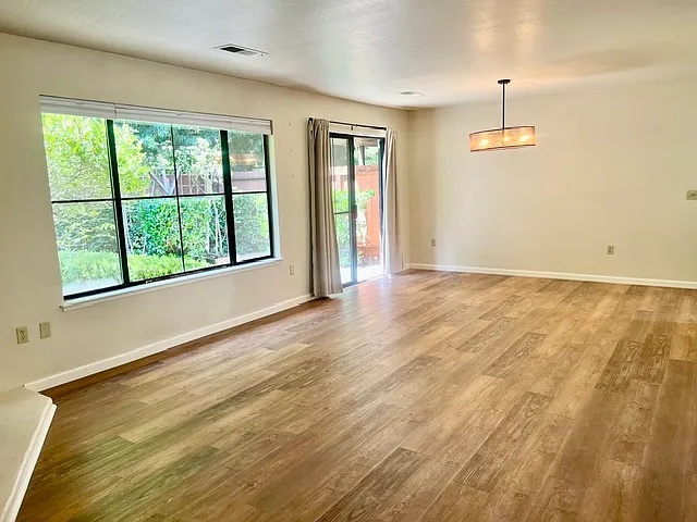 large living room with gas fireplace, and dining area