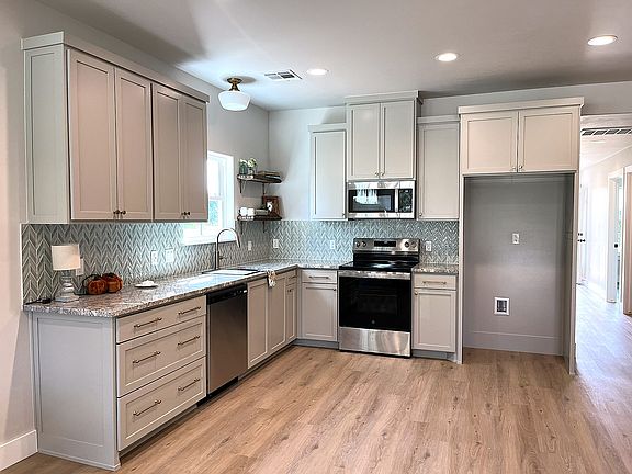 Kitchen includes dishwasher, microwave, and electric stove. (this photo is from neighboring unit 10465)