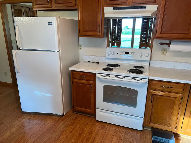Pass through to Dining Room over stove with wood shutters.
Stove and refrigerator go with rental