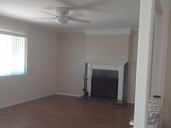 Large living room with beautiful working fireplace. Smooth ceilings and crown moldings and baseboards.