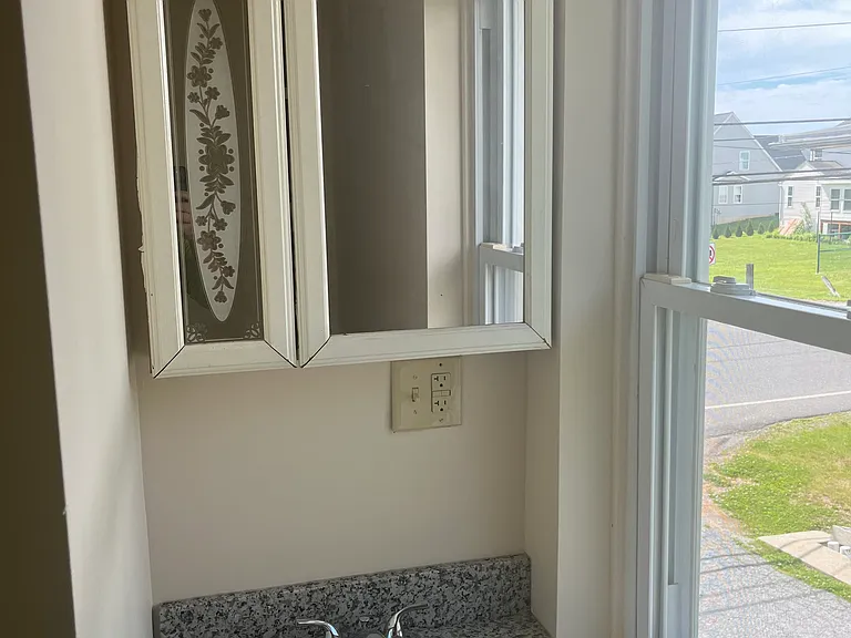 Bathroom sink with vanity below and mirror vanity