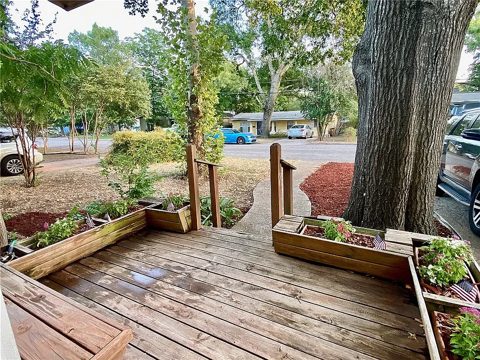 Most charming curb appeal and entrance, surrounded by flower boxes with freshly planted flowers welcoming the new residents, plus a cozy front porch bench perfect for relaxing.