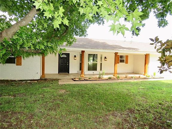 Beautiful trees shade the front of the home.