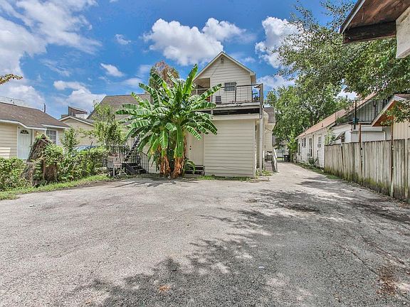 Private entrance at the rear of home, at right of banana tree. Reserved parking closest to the house on left side of photo.