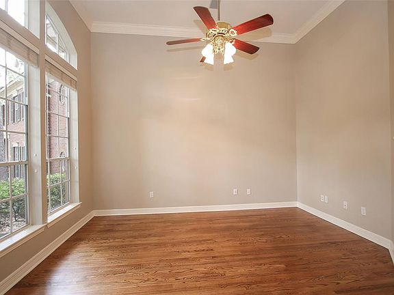 Formal living room with large windows and crown molding