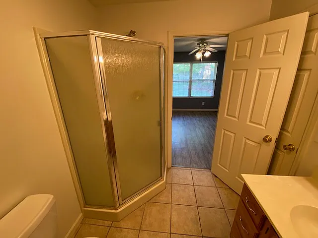 First floor full bathroom with access to bedroom and sizeable walk-in closet and another door to hall.