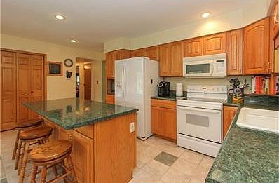 Spacious Kitchen has Center Island, Pantry and Tile Flooring.