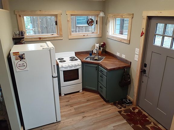 Full kitchen with pots, pans, utensils, dishes, etc