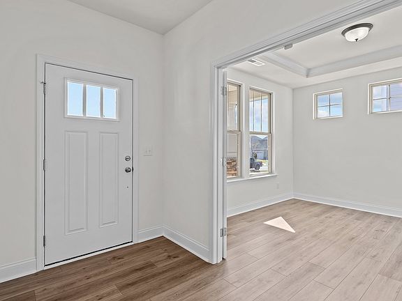 Norris Design inviting wide-entry front door and study with raised tray ceiling. At Lakeside Glen by