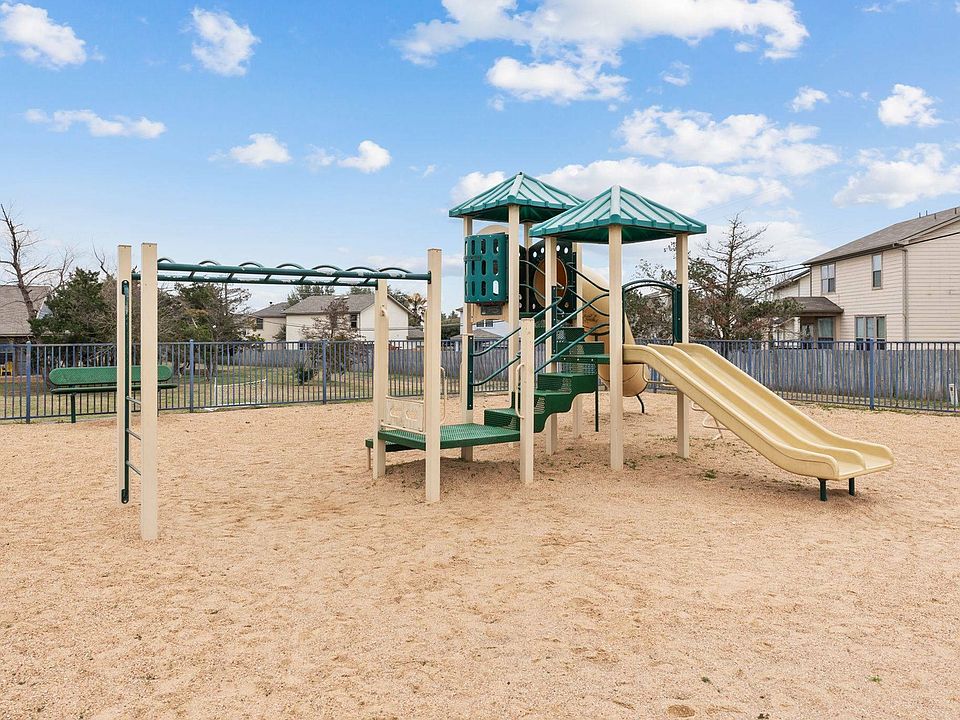 Children playing at the Crescent Village Apartments playground in Elgin, TX