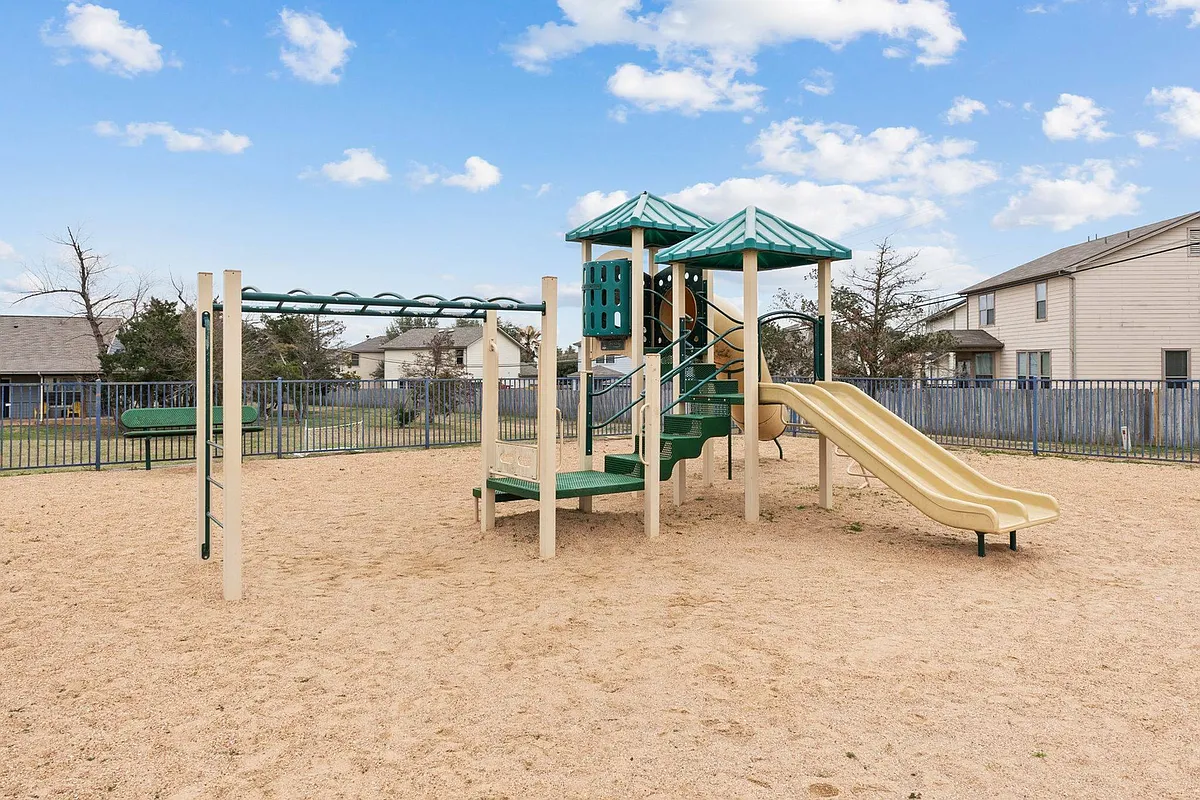 Children playing at the Crescent Village Apartments playground in Elgin, TX - Crescent Village