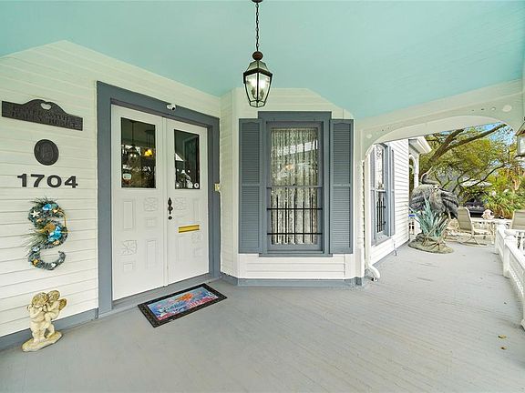 Greeted by antique wooden doors & a large wrap around patio