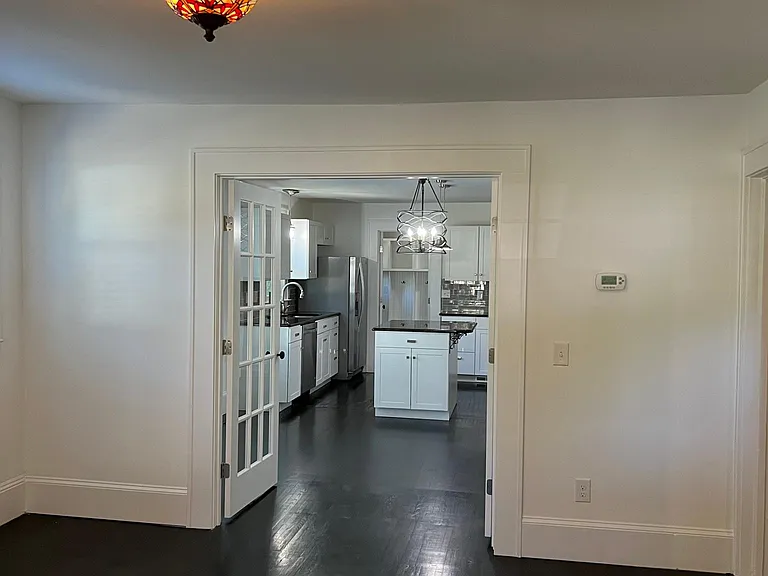 Your living room opens into the dining area and kitchen, though easily separated by French doors if needed.