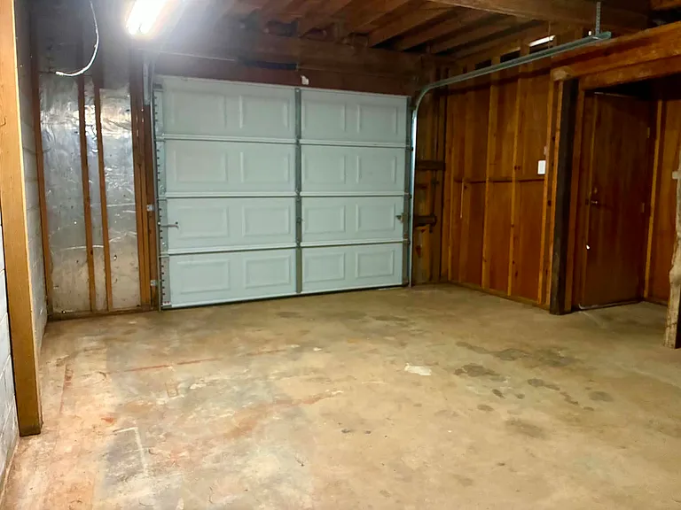 view of boat garage looking outward- note door on far right, entrance to basement
