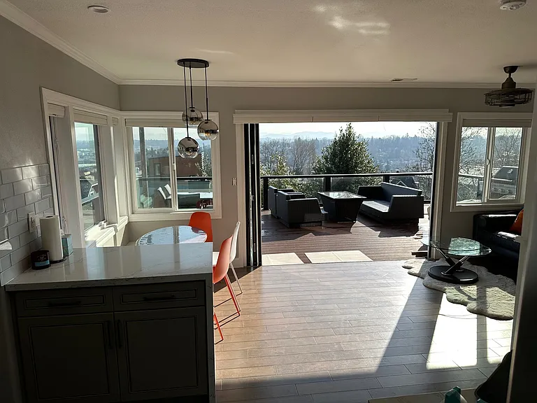 from kitchen looking out opened folding doors breakfast nook to left.