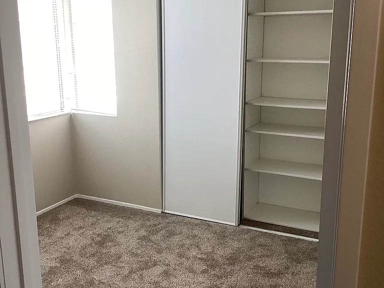 Middle bedroom with customized closet.