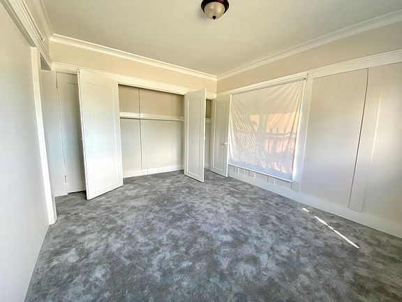 The entire living room wall is closet space for storage