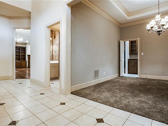 A grand foyer welcomes you with an arched rounded ceiling and inlaid floors