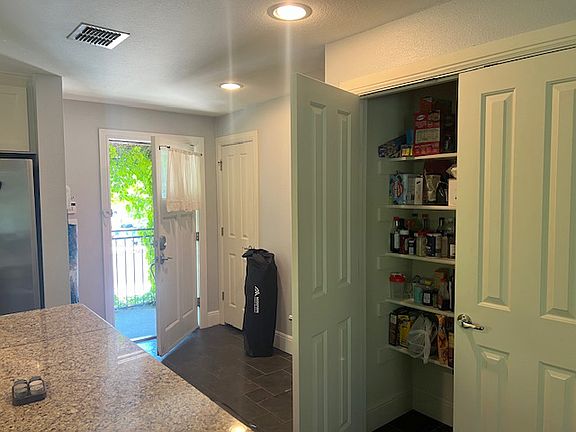 Double door pantry and second utilities closet. Door opens to outside