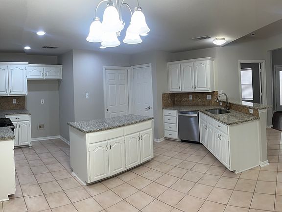 Kitchen has freshly painted cabinets