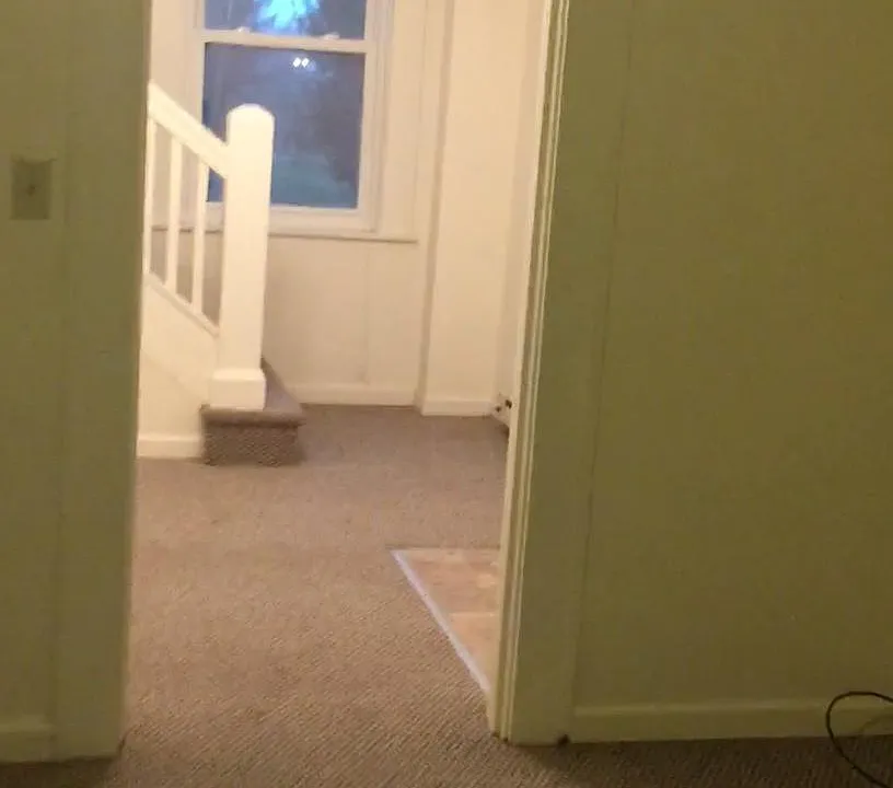 View of foyer and stairs from living room.