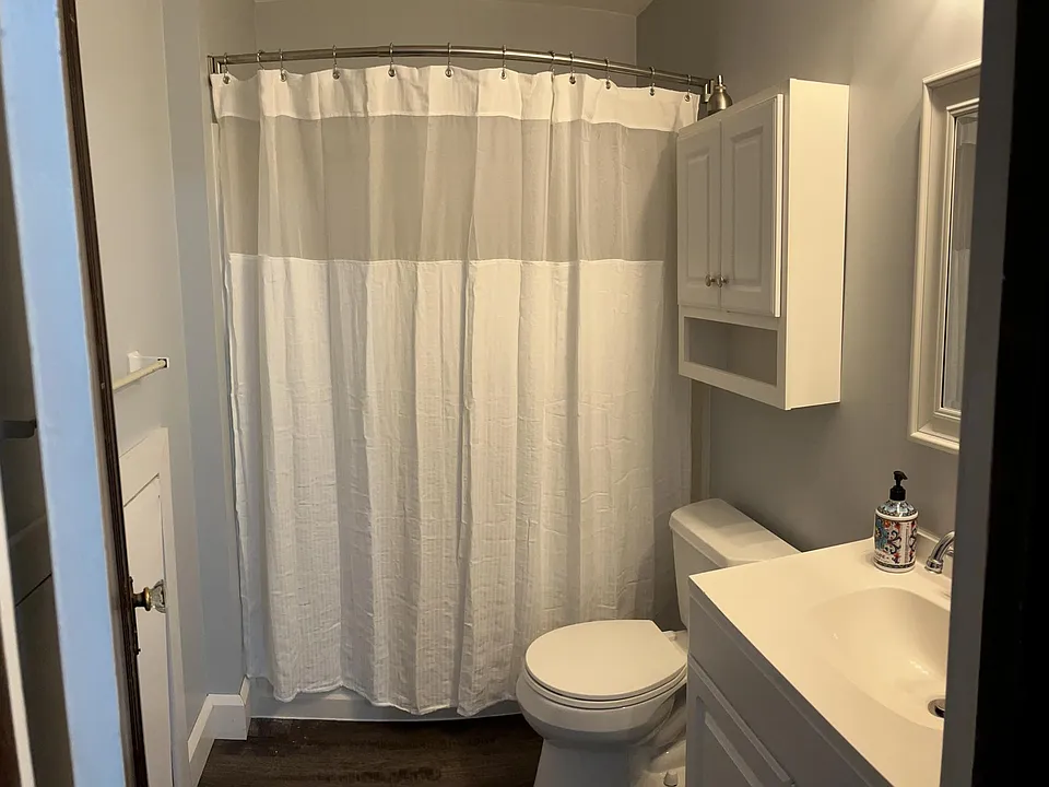 Bathroom freshly painted with new floors.