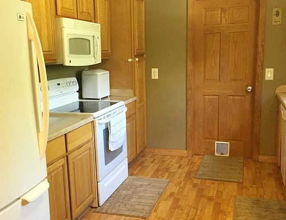 Off the back entry is the kitchen area. It has been totally redone and features Oak cabinets, lamina