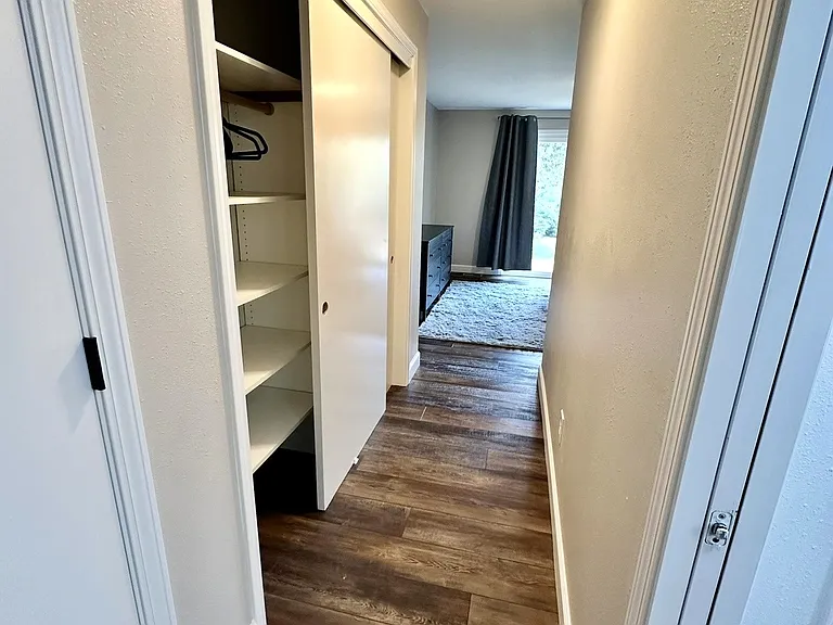 Primary bedroom hall with closet between room and bathroom
