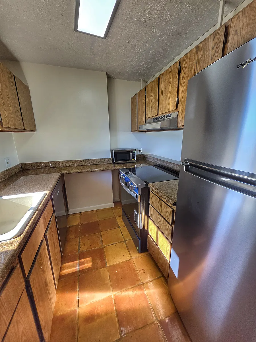 Kitchen has new appliances, dishwasher, refrigerator, range, and microwave. - 2121 Ala Wai Blvd #1205